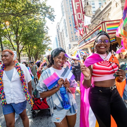 Emory students, including Malia Wakesho-Ajwang (center) and Mariam Egberongbe (right), participate in the Atlanta Pride Parade as it moves up Peachtree Street on Sunday, Oc.t 9, 2022. This was the first time the parade had been held since 2019 because of the pandemic. (Photo: Jenni Girtman for The Atlanta Journal-Constitution)