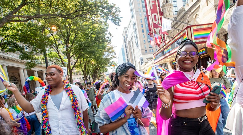 Emory students, including Malia Wakesho-Ajwang (center) and Mariam Egberongbe (right), participate in the Atlanta Pride Parade as it moves up Peachtree Street on Sunday, Oc.t 9, 2022. This was the first time the parade had been held since 2019 because of the pandemic. (Photo: Jenni Girtman for The Atlanta Journal-Constitution)