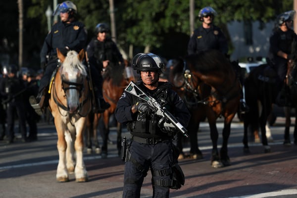 A Los Angeles Metro police officer stands guard during a protest on Wednesday, June 11, 2025, in Los Angeles. (AP Photo/Ethan Swope)
