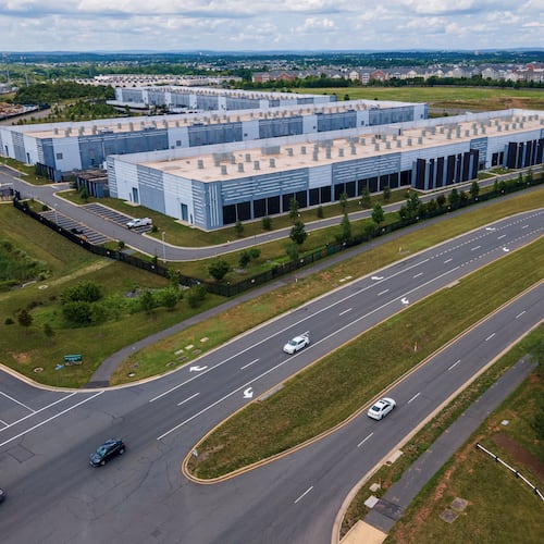 FILE - Cars drive past data centers, July 16, 2023, in Ashburn, Va. (AP Photo/Ted Shaffrey, File)