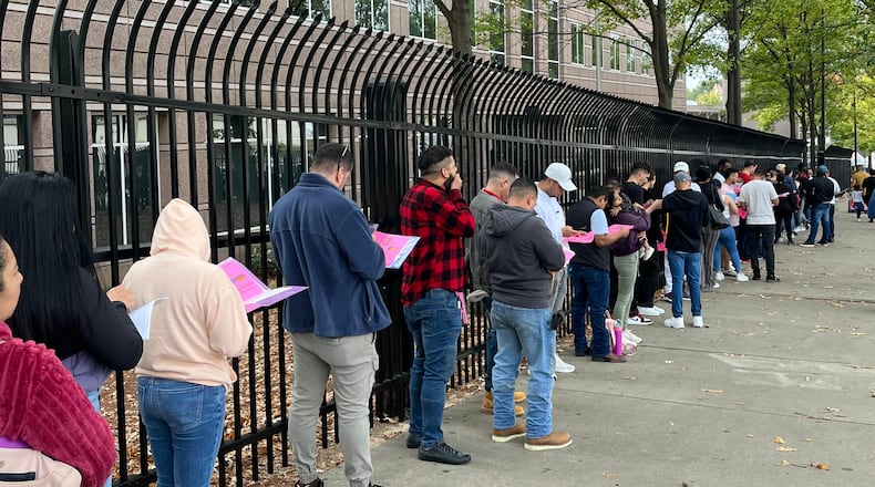 Migrants wait in line Wednesday to check in at the Atlanta field office of Immigration and Customs Enforcement. Lautaro Grinspan/AJC