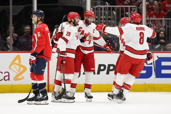 Carolina Hurricanes center Jordan Staal (11) celebrates his goal with teammates in the first period of Game 5 of a second-round NHL hockey playoff series as Washington Capitals defenseman Jakob Chychrun (6) skates by Thursday, May 15, 2025, in Washington. (AP Photo/Nick Wass)
