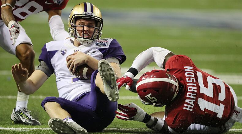 Alabama defensive back Ronnie Harrison tackles Washington quarterback Jake Browning on a quarterback keeper during the second quarter in the Chick-fil-A Peach Bowl at the Georgia Dome on Saturday, Dec. 31, 2016, in Atlanta. Curtis Compton/ccompton@ajc.com