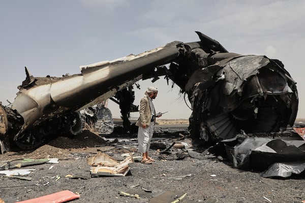 A Yemeni officer inspects the wreckage of a destroyed civilian aircraft following Israeli airstrikes on Sanaa International Airport in Sanaa, Yemen, Wednesday, May 7, 2025. (AP Photo/Osamah Abdulrahman)