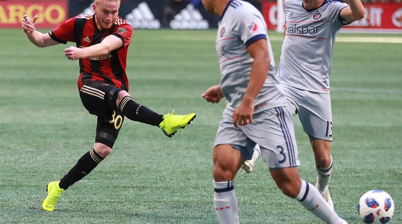 Atlanta United midfielder Andrew Carleton gets off a shot on goal between Chicago Fire defenders Brandon Vincent and Brandt Bronico during the second half in a MLS soccer match on Sunday, Oct 21, 2018, in Atlanta.   Curtis Compton/ccompton@ajc.com