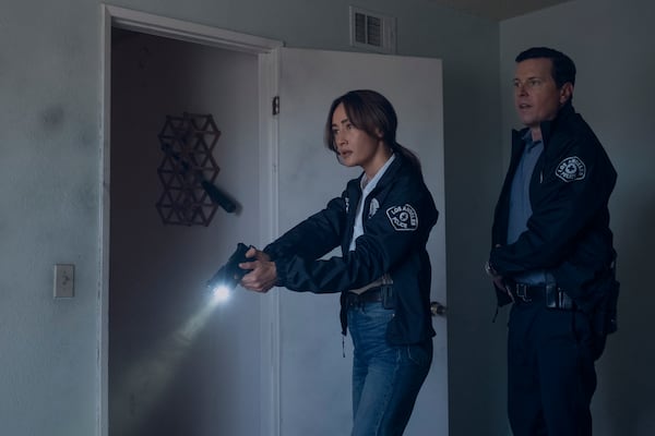 This image released by Amazon Prime shows Maggie Q and Michael Mosley in a scene from the series "Ballard." (Patrick Wymore/Prime Video via AP)