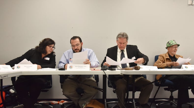 Members of the Gwinnett County Board of Registrations and Elections (from left) Alice O'Lenick, John Mangano, Stephen Day and Ben Satterfield confer during their meeting at Gwinnett County Voter Registrations and Elections Office on Tuesday, November 13, 2018. HYOSUB SHIN / HSHIN@AJC.COM
