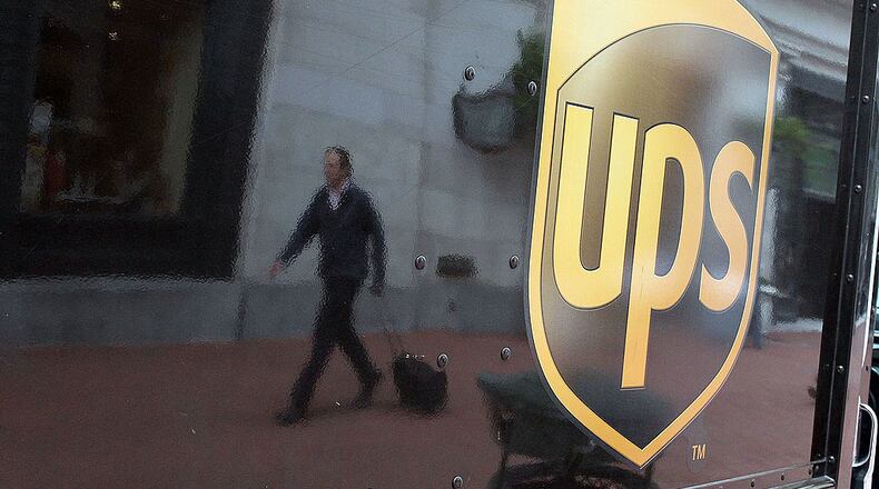 SAN FRANCISCO - FEBRUARY 02: A pedestrian is reflected in the side of a United Parcel Service (UPS) truck February 2, 2010 in San Francisco, California. UPS reported a surge in fourth-quarter earnings with a profit of $757 million, or 75 cents a share, compared to $254 million, or 25 cents a share, one year ago. (Photo by Justin Sullivan/Getty Images)