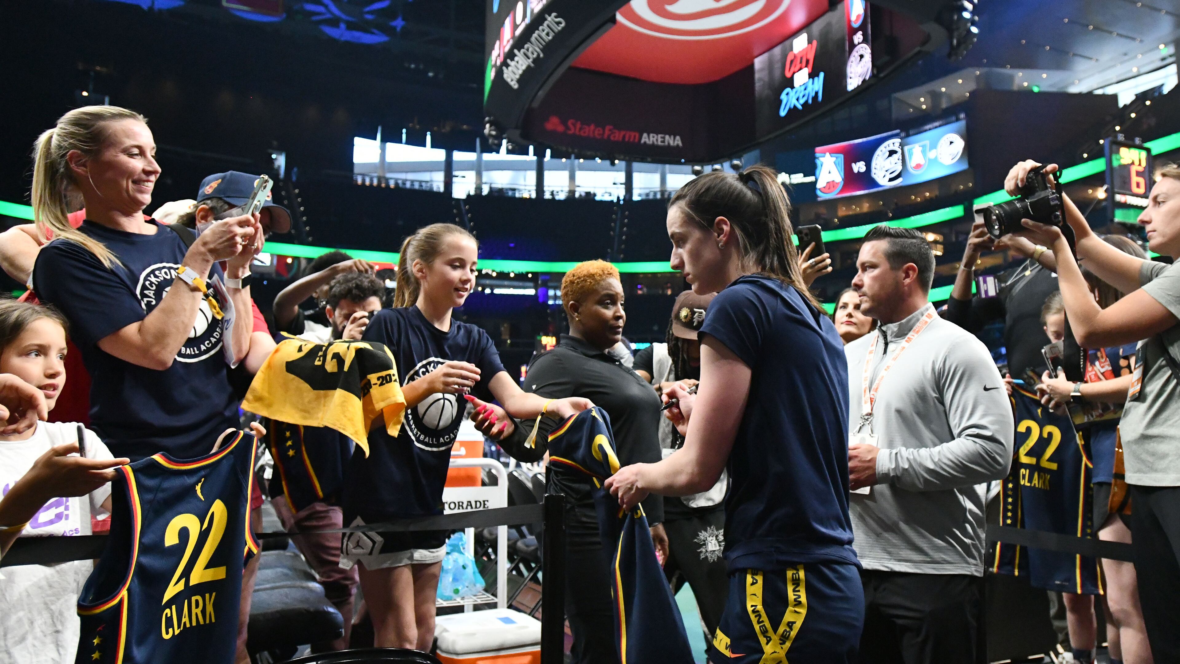 Indiana Fever guard Caitlin Clark (22) signs autographs for young fans before Atlanta Dream’s home opener against Indiana Fever at State Farm Arena, Thursday, May 22, 2025, in Atlanta. (Hyosub Shin / AJC)
