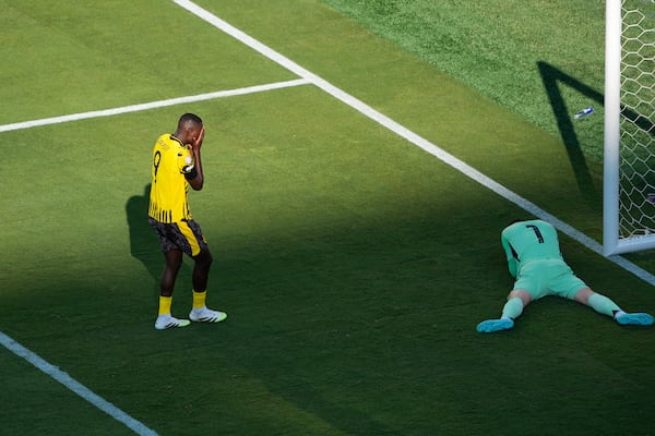 Borussia Dortmund's Serhou Guirassy, left reacts after missing a chance to score in front of Real Madrid's goalkeeper Thibaut Courtois during the Club World Cup quarterfinal soccer match between Real Madrid and Borussia Dortmund in East Rutherford, N.J., Saturday, July 5, 2025. (AP Photo/Pamela Smith)