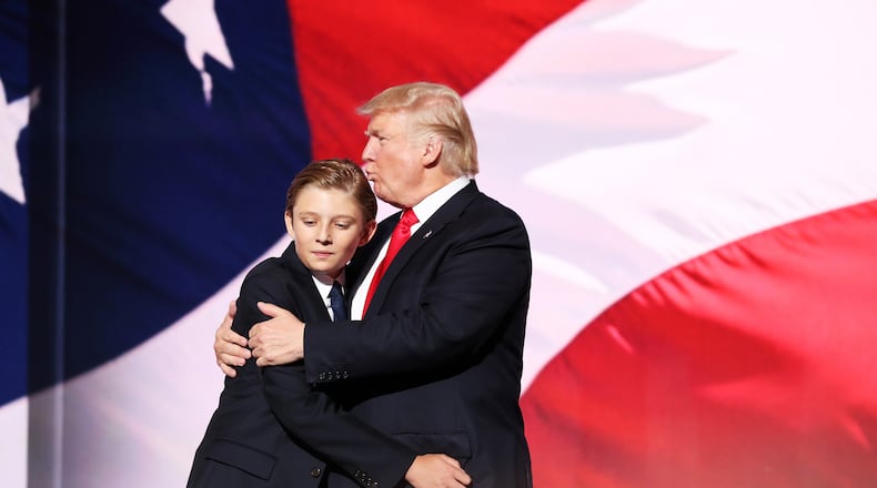 CLEVELAND, OH - JULY 21: Donald Trump embraces his son Barron Trump after he delivered his speech on the fourth day of the Republican National Convention on July 21, 2016 at the Quicken Loans Arena in Cleveland, Ohio. (Photo by John Moore/Getty Images)