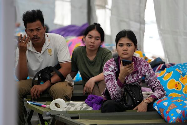 Punyang, 28, right, from Cambodia, sits with her relatives who have come to look for their uncle, who was working in an under-construction high-rise building that collapsed in an earthquake, in Bangkok, Thailand, Monday, March, 31, 2025. (AP Photo/Manish Swarup)