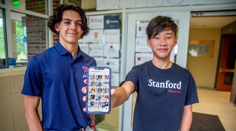 Atlanta International School seniors Rodrigo Villagomez (L) and George Song show their Instagram account called Futures of AIS 2021 witch lets fellow classmates know what college they've committed to. STEVE SCHAEFER FOR THE ATLANTA JOURNAL-CONSTITUTION