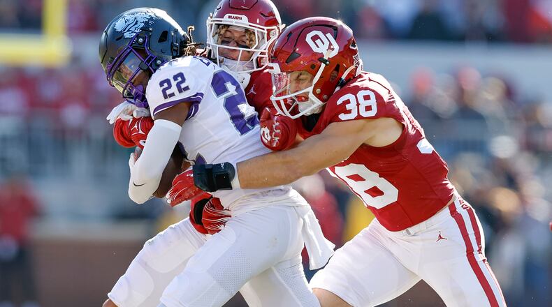 FILE - Oklahoma linebacker Owen Heinecke (38) tackles TCU wide receiver Major Everhart (22) during the second half of an NCAA college football game, Nov. 24, 2023, in Norman, Okla. (AP Photo/Alonzo Adams, File)