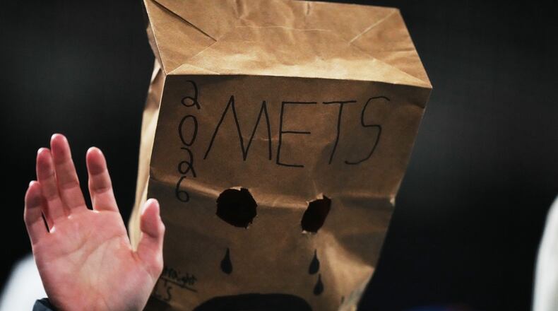 A New York Mets fan watches during the eighth inning of a baseball game against the Minnesota Twins Tuesday, April 21, 2026, in New York. (AP Photo/Frank Franklin II)