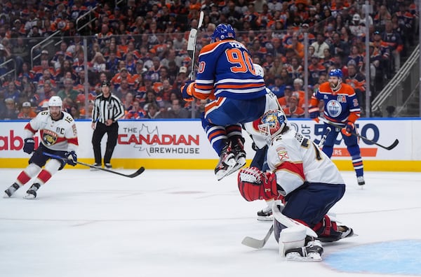 Florida Panthers goalie Sergei Bobrovsky (72) makes the save as Edmonton Oilers' Corey Perry (90) jumps in front of him during the second period in Game 2 of the NHL hockey Stanley Cup Finals, in Edmonton, Alberta, Friday, June 6, 2025. (Darryl Dyck/The Canadian Press via AP)