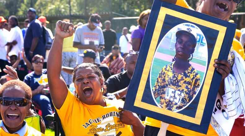 At a big screen viewing party in Chicago, fans of The Jackie Robinson West Little League team celebrate a victory during the first round of the Little League World Series being played in South Williamsport, Pa., Thursday, Aug. 14, 2014. (AP Photo/Sun-Times Media, Michael Schmidt)