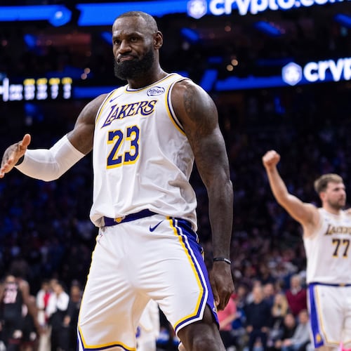 Los Angeles Lakers' LeBron James, left, reacts to his three point shot with Luka Doncic, right, celebrating during the second half of an NBA basketball game against the Philadelphia 76ers, Sunday, Dec. 7, 2025, in Philadelphia. (AP Photo/Chris Szagola)