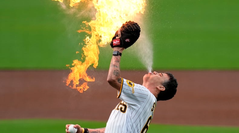 Entertainer Steve-O, from the "Jackass" series, prepares to throw the ceremonial first pitch with flames before the San Diego Padres host the Kansas City Royals in a 2023 baseball game in San Diego. (AP Photo/Gregory Bull)