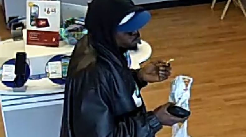 A Metro PCS store in Gwinnett County was robbed March 30 by a man who ate chips during the holdup. (Credit: Gwinnett County Police Department)