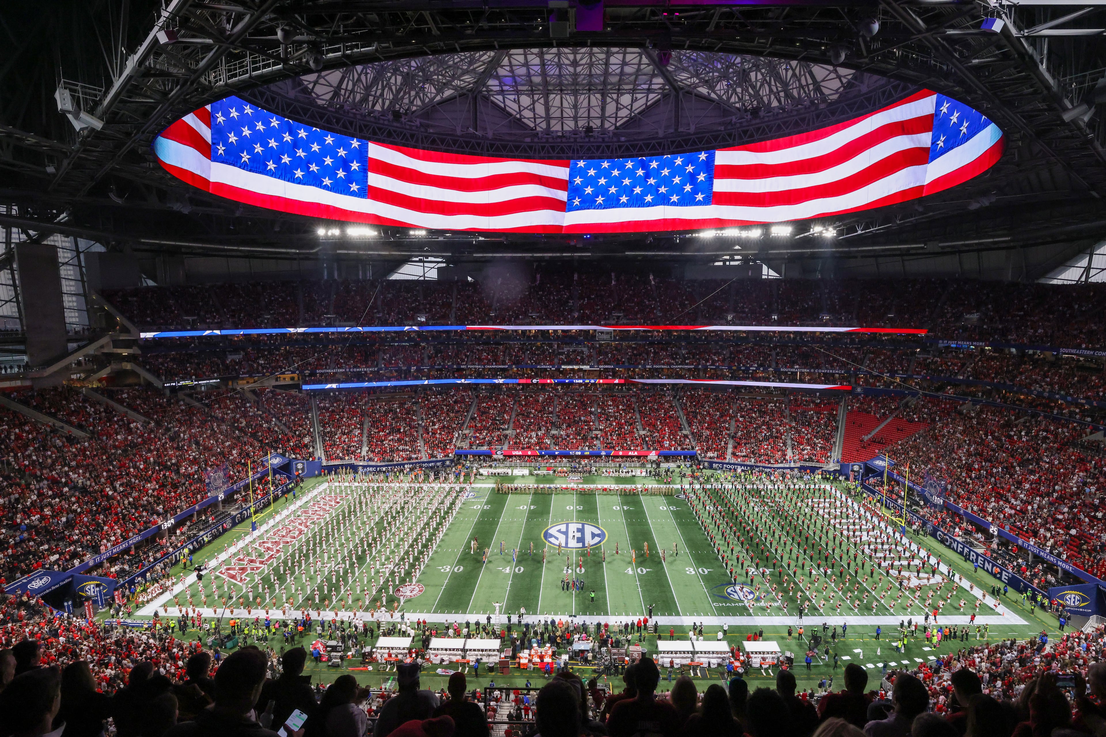 Georgia and Alabama marching bands line up to perform the national anthem to begin the SEC Championship Game at Mercedes-Benz Stadium, Saturday, Dec. 6, 2025, in Atlanta. (Jason Getz / AJC)