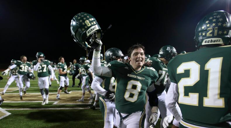 November 7, 2014 - Roswell, Ga: Blessed Trinity fullback Jake Bogosian (8) celebrates with teammates after their win over Cedar Grove Friday November 7, 2014, in Roswell, Ga.. Blessed Trinity won 28-21 to win the region championship. JASON GETZ / SPECIAL