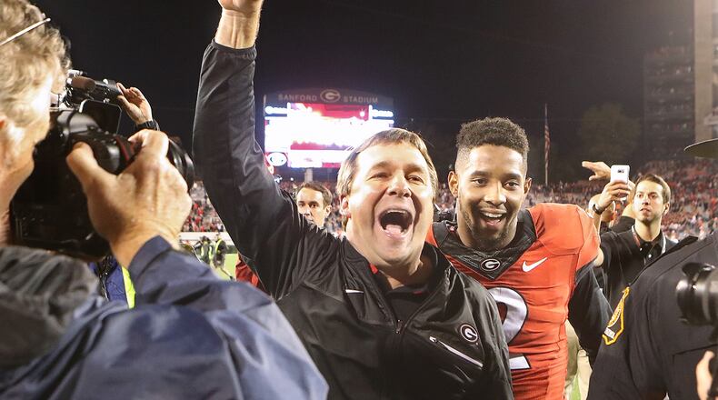 November 12, 2016, Athens: Georgia head coach Kirby Smart and defensive back Maurice Smith, who intercepted a pass and returned it for a touchdown, celebrate a 13-7 victory over Auburn in an NCAA college football game on Saturday, Nov. 12, 2016, in Athens. Curtis Compton/ccompton@ajc.com