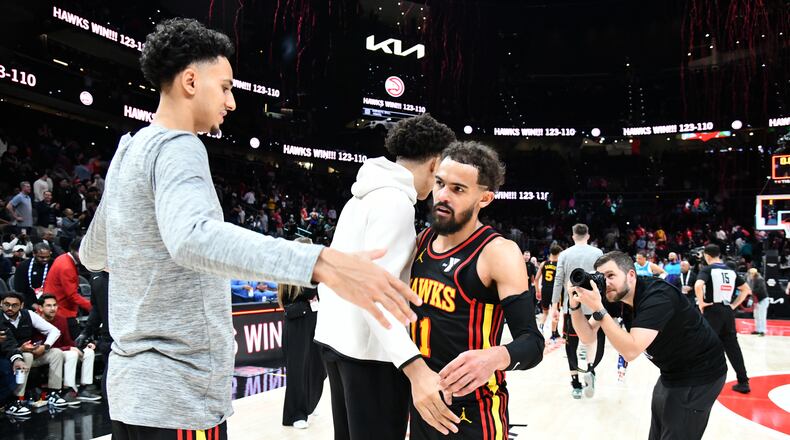 Atlanta Hawks guard Trae Young (11) celebrates with teammates after Atlanta Hawks beat Charlotte Hornets  during an NBA basketball game at State Farm Arena, Wednesday, March 12, 2025, in Atlanta. Atlanta Hawks won 123-110 over Charlotte Hornets. (Hyosub Shin / AJC)