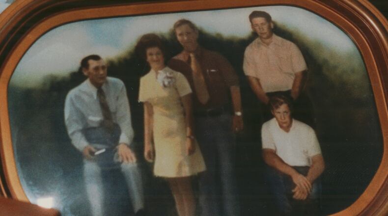 May 12, 1993 - SEMINOLE COUNTY, GA -- Ned Alday's widow, Ernestine, holds a photograph of slain members of her Seminole farm family: her husband, brother-in-law, three sons and daughter-in-law. (Stringer/AP)