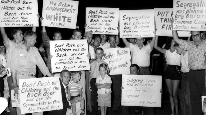 Demonstrators in 1959 display their signs and slogans outside the Governor's Mansion in Atlanta protesting desegregation of schools and public facilities. (Bill Wilson / AJC file photo)