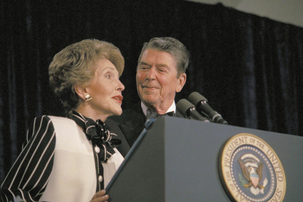 FILE - President Ronald Reagan watches as first lady Nancy Reagan comments from the podium during the White House Correspondents' Association annual dinner on April 23, 1987, in Washington. (AP Photo/Charles Tasnadi, File)