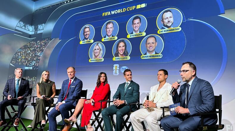 Fox Sports hosts, from left, Rob Stone and Rebecca Lowe, and former player/analysts Alexi Lalas, Stu Holden and Javier Hernandez listen as Fox Sports' vice president of production Zac Kenworthy speaks during a World Cup soccer new conference, Thursday, May 21, 2026, in New York. (AP Photo/Ronald Blum)