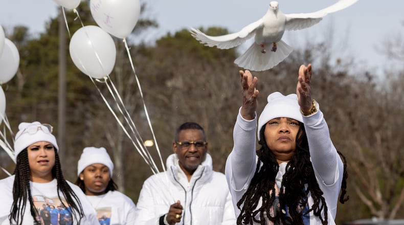 Friends, relatives and colleagues of Stacy Redmond, including co-worker Myshirdie Welch, gathered Wednesday for a vigil at the Kroger where he worked in Tucker.