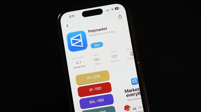 FILE - The prediction market app Polymarket is displayed on a mobile phone, April 16, 2026, in Chicago. (AP Photo/Erin Hooley, File)