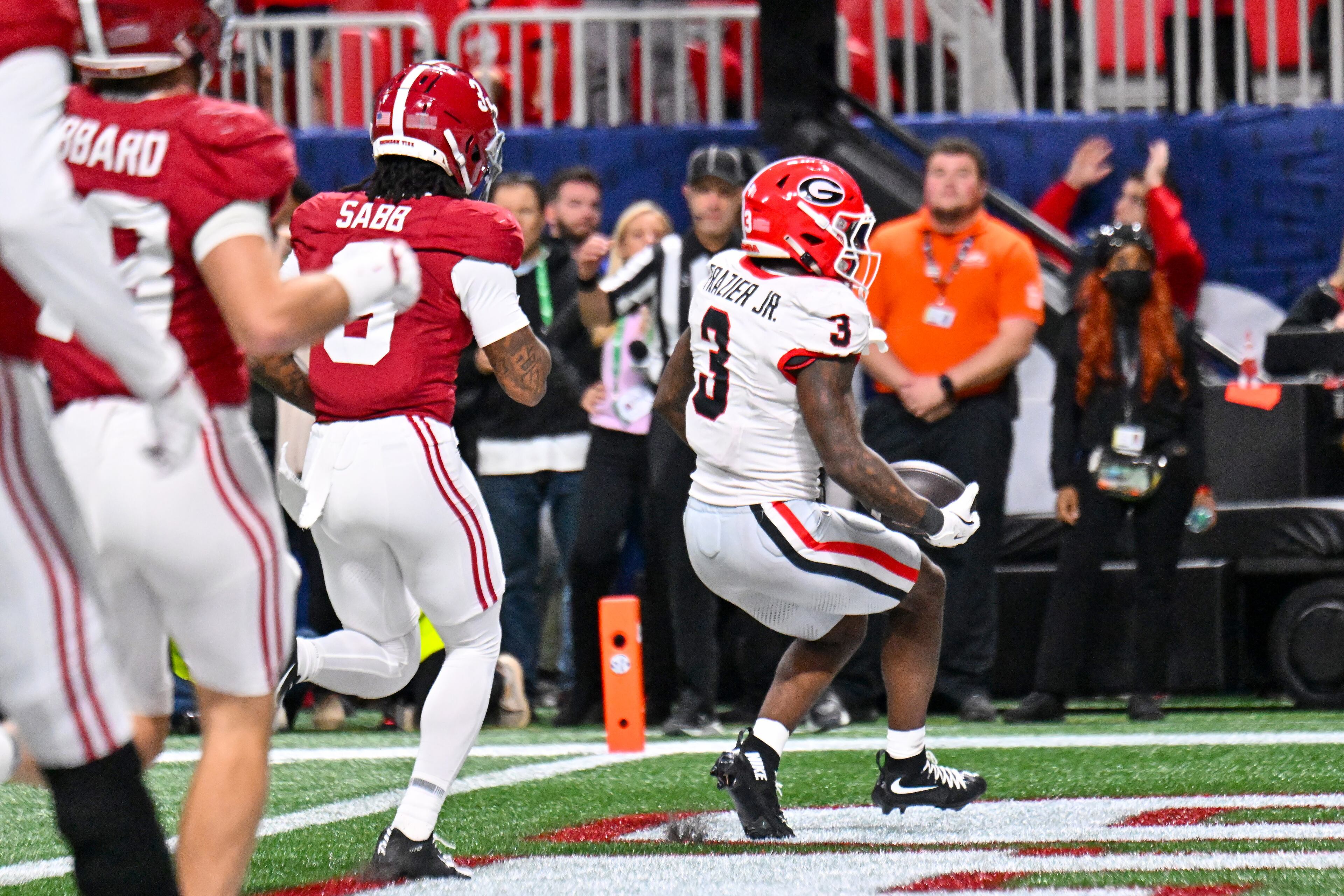 Georgia running back Nate Frazier (3) runs nine yards for a touchdown against Alabama defensive back Keon Sabb (3) during the third quarter of the SEC Championship game at Mercedes-Benz Stadium, Saturday, Dec. 6, 2025, in Atlanta. (Hyosub Shin / AJC)