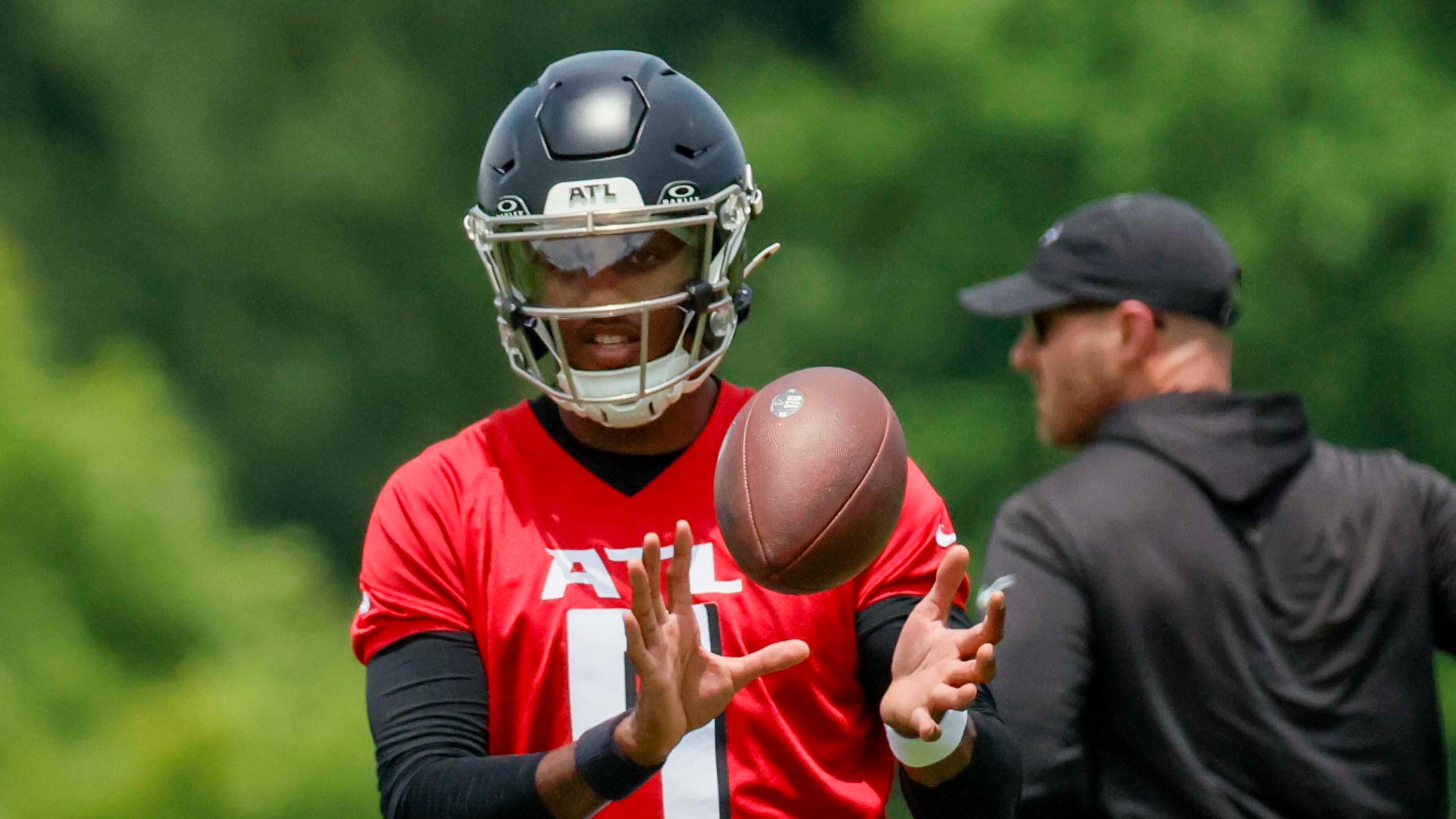Unlike last season, when Kirk Cousins was the undisputed starter for the Atlanta Falcons at quarterback heading into training camp, this season it's Michael Penix Jr. (center). Training camp begins next week. (Miguel Martinez/AJC)