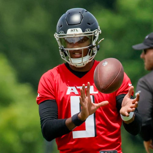 Unlike last season, when Kirk Cousins was the undisputed starter for the Atlanta Falcons at quarterback heading into training camp, this season it's Michael Penix Jr. (center). Training camp begins next week. (Miguel Martinez/AJC)