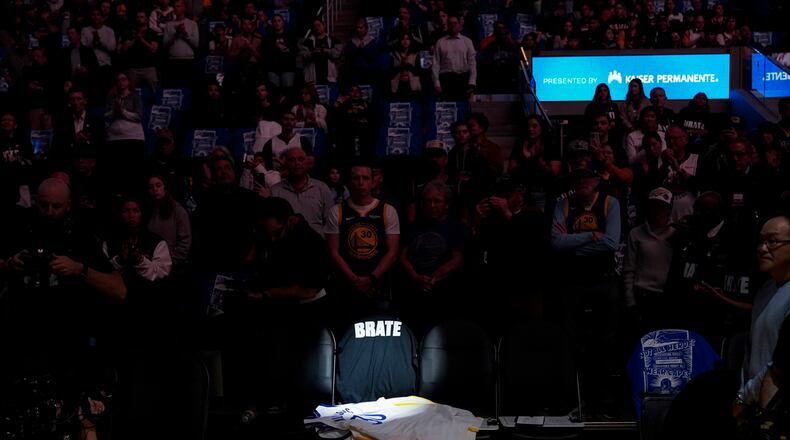 A spotlight shines on the seat of late Golden State Warriors assistant coach Dejan Milojevic, who died Jan. 17 after suffering a heart attack, before an NBA basketball game between the Warriors and the Atlanta Hawks, Wednesday, Jan. 24, 2024, in San Francisco. (AP Photo/Godofredo A. Vásquez)