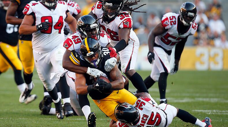 PITTSBURGH, PA - AUGUST 20: James Conner #30 of the Pittsburgh Steelers rushes against Kemal Ishmael #36, Deron Washington #49 and Marcelis Branch #35 of the Atlanta Falcons during a preseason game at Heinz Field on August 20, 2017 in Pittsburgh, Pennsylvania. (Photo by Justin K. Aller/Getty Images)