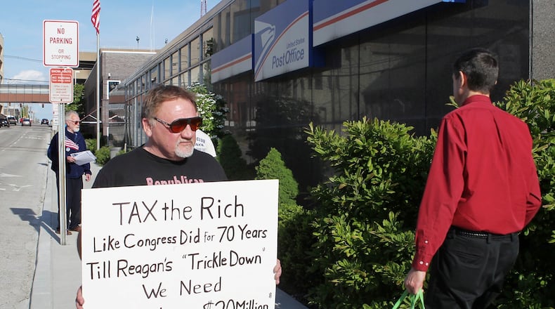 FILE - In this April 17, 2012, photo, James Hodgkinson of Belleville protests outside of the United States Post Office in Downtown Belleville, Ill. A government official says the suspect in the Virginia shooting that injured Rep. Steve Scalise and several others has been identified Hodgkinson. (Derik Holtmann/Belleville News-Democrat, via AP)