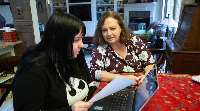 Stephanie Fuhrmannek helps her daughter Emily with her math homework at their Dacula home on January 8, 2020. All Gwinnett County Public Schools students will learn digitally Tuesday so teachers can plan. STEVE SCHAEFER FOR THE ATLANTA JOURNAL-CONSTITUTION