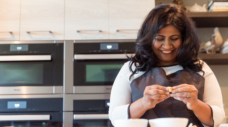 Chef Asha Gomez prepares a traditional South Indian sweet that her mother, now 80 years old, made and gave as gifts during the holidays. (Jenni Girtman / Atlanta Event Photography)
