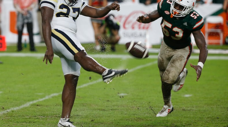 Georgia Tech punter Pressley Harvin III (27) kicks the ball as Miami linebacker Zach McCloud (53) attempts to block during the second half of an NCAA College football game, Saturday, Oct. 14, 2017 in Miami Gardens, Fla. Miami defeated Georgia Tech 25-24. (AP Photo/Wilfredo Lee)