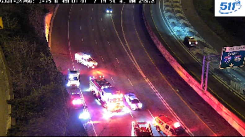 A vehicle flipped over a barrier wall on the Buford Spring Connector and rolled onto I-75 early Saturday morning, according to police.