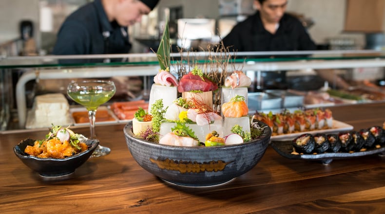 Fudo Sashimi Platter with Dynamite Shrimp and The Zen cocktail on left, Escape (10) Limited roll and Spicy Mega Tuna roll on right. Photo credit- Mia Yakel.