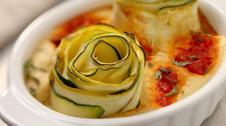 Harissa Swirl ‘Banzo Bake from “YumUniverse: Pantry to Plate” by Heather Crosby sports a flatbread base made with garbanzo (hence ‘banzo) flour, curled zucchini ribbons and a harissa sauce. (Michael Tercha/Chicago Tribune/TNS)