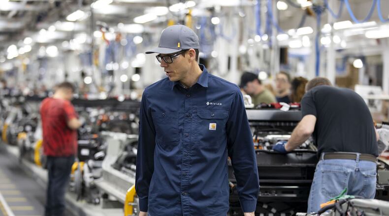 Rivian founder and CEO R.J. Scaringe watches as workers build chassis at the electric vehicle plant in Normal, Illinois. The electric vehicle company has faced backlash from locals living near the site of its new $5 billion plant that will be built about an hour east of Atlanta. (Brian Cassella/Chicago Tribune/TNS)