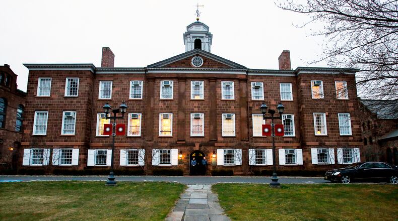 FILE - Lights glow in Rutgers University's Old Queens building, April 4, 2013, in New Brunswick, N.J. (AP Photo/Mel Evans, File)