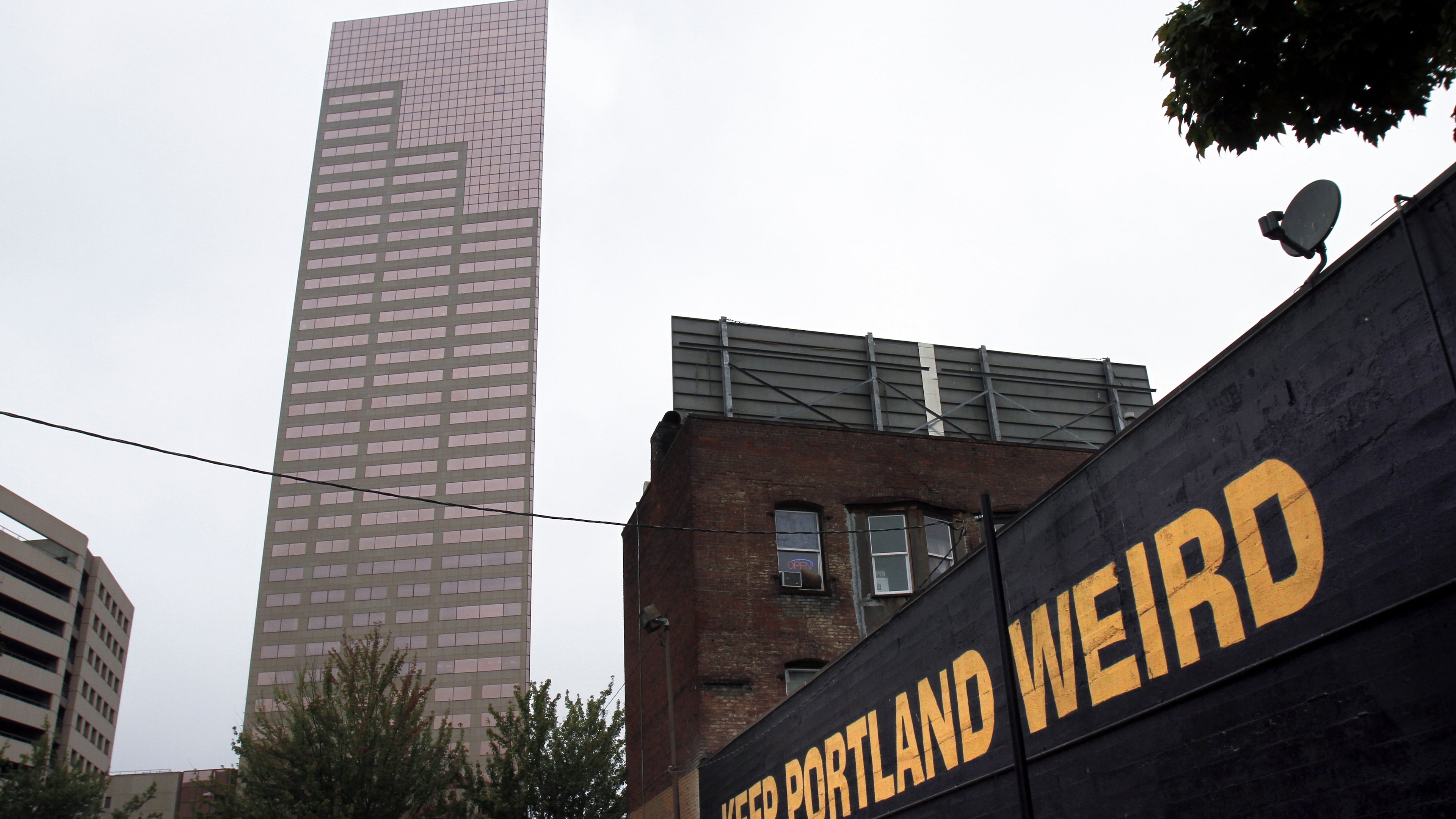 FILE - A downtown building displays a popular slogan in relation to the city in Portland, Ore., Sept. 19, 2012. (AP Photo/Don Ryan, File)