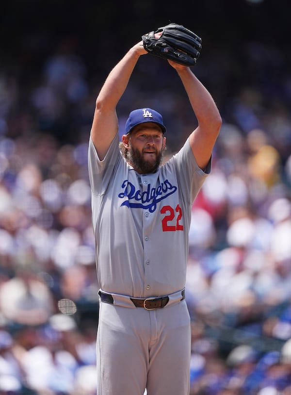 Los Angeles Dodgers starting pitcher Clayton Kershaw goes into the stretch to keep a runner on first base in the third inning of a baseball game against the Colorado Rockies, Thursday, June 26, 2025, in Denver. (AP Photo/David Zalubowski)